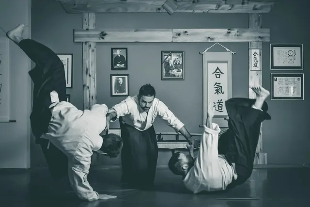 Projection d’aïkido dans un dojo, en noir et blanc
